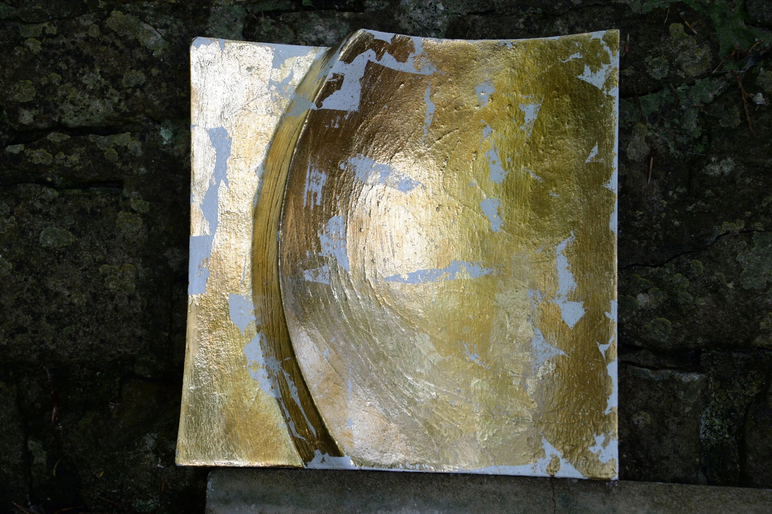 White and gold-coloured Moonphase panel with a deep curved bowl, photographed against stone.