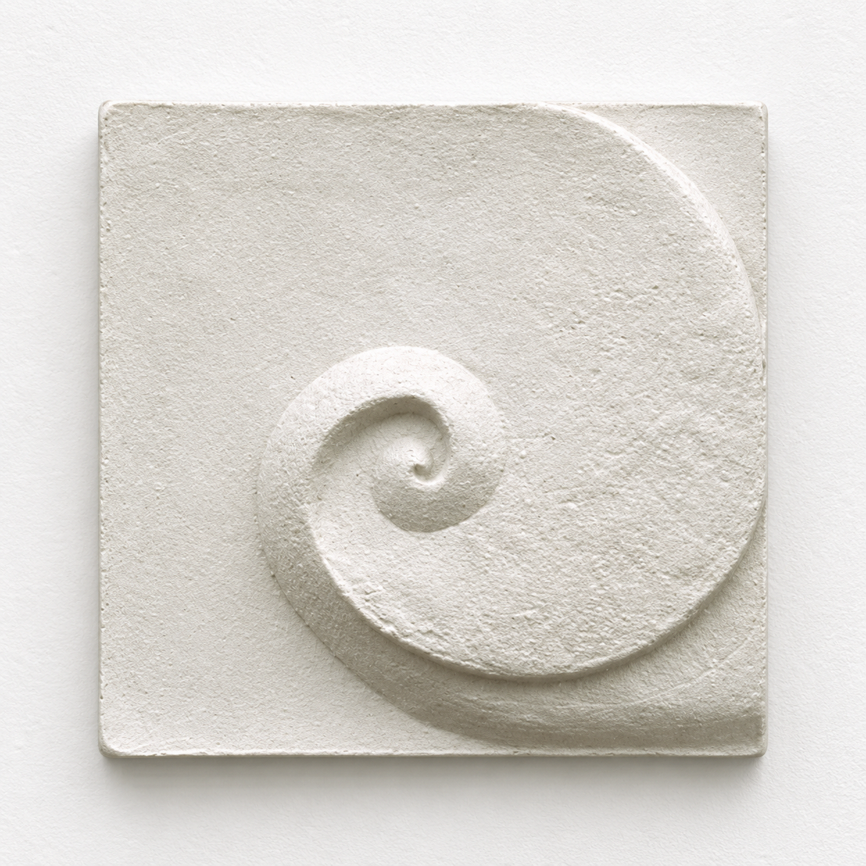White Moonphase 1 relief with a shallow coiled centre and textured surface.