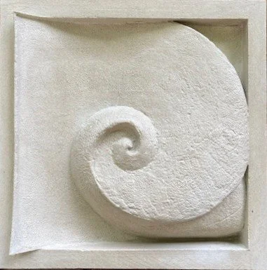 Bordered white Moonphase 1 spiral panel photographed at an angle in the workshop.