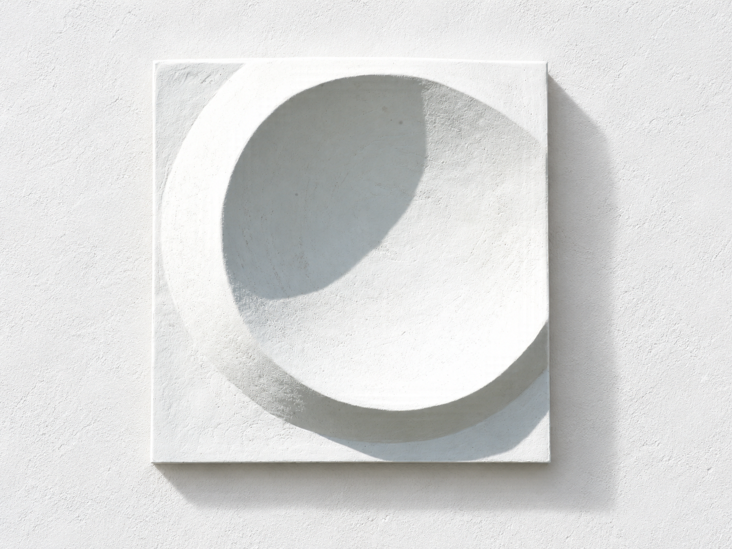 White Moonwater Catcher panel with a deep circular bowl casting a shadow on a white wall.