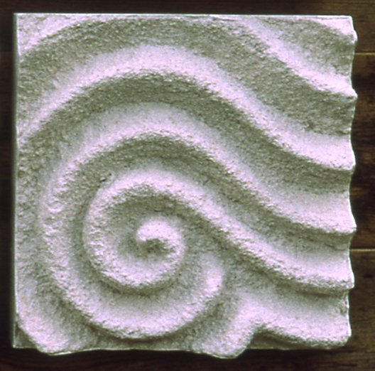 Raked Spiral 1 relief with rough parallel ridges curling into a spiral, photographed in outdoor light.