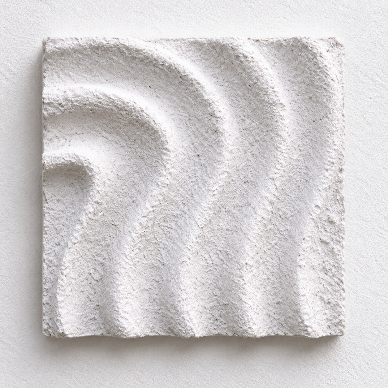 White Raked Spiral 2 relief arranged vertically against a pale background.