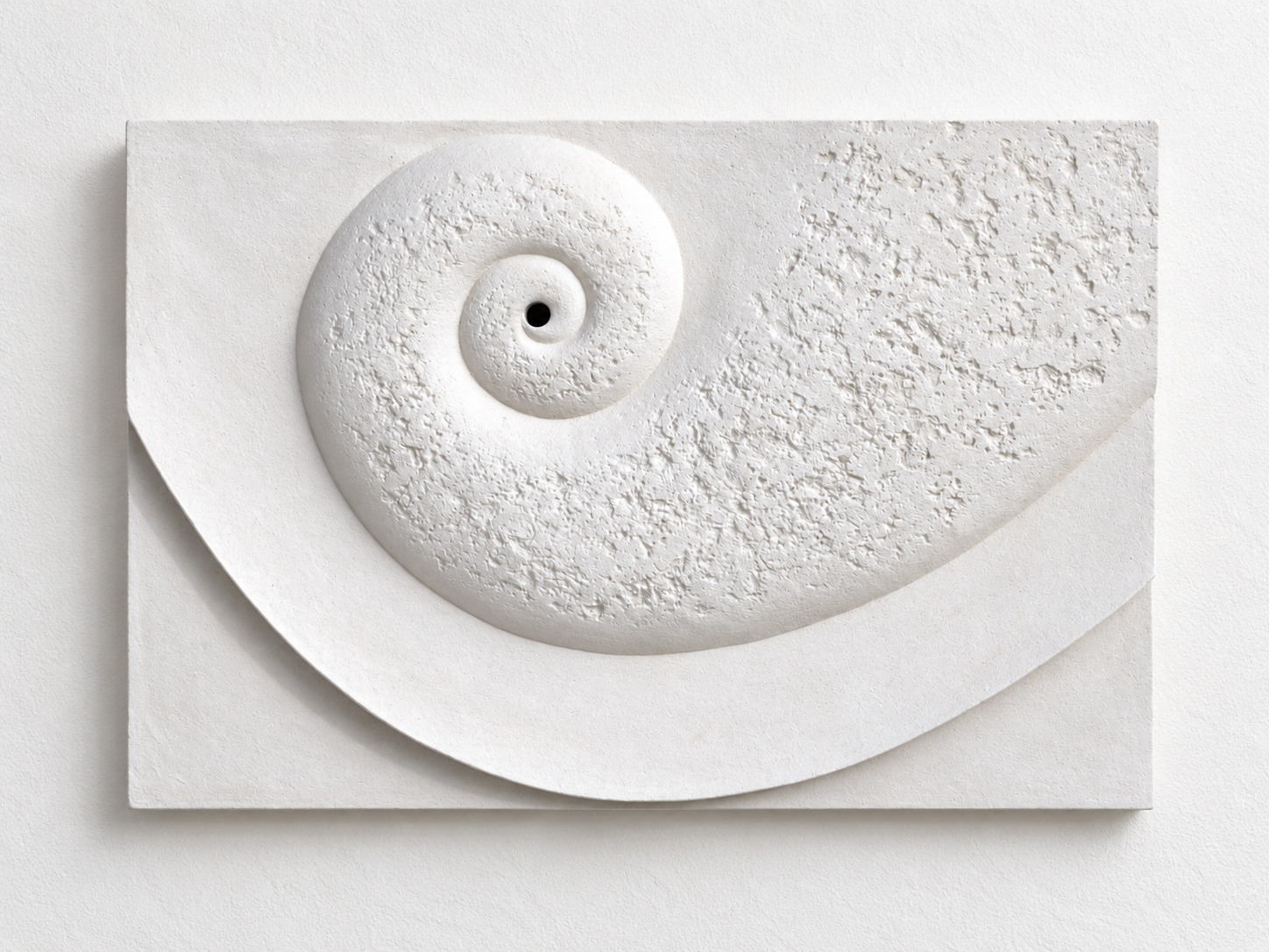 Close view of the white Battersea Shellmoon 3 Water Feature relief, showing the coiled centre and texture.