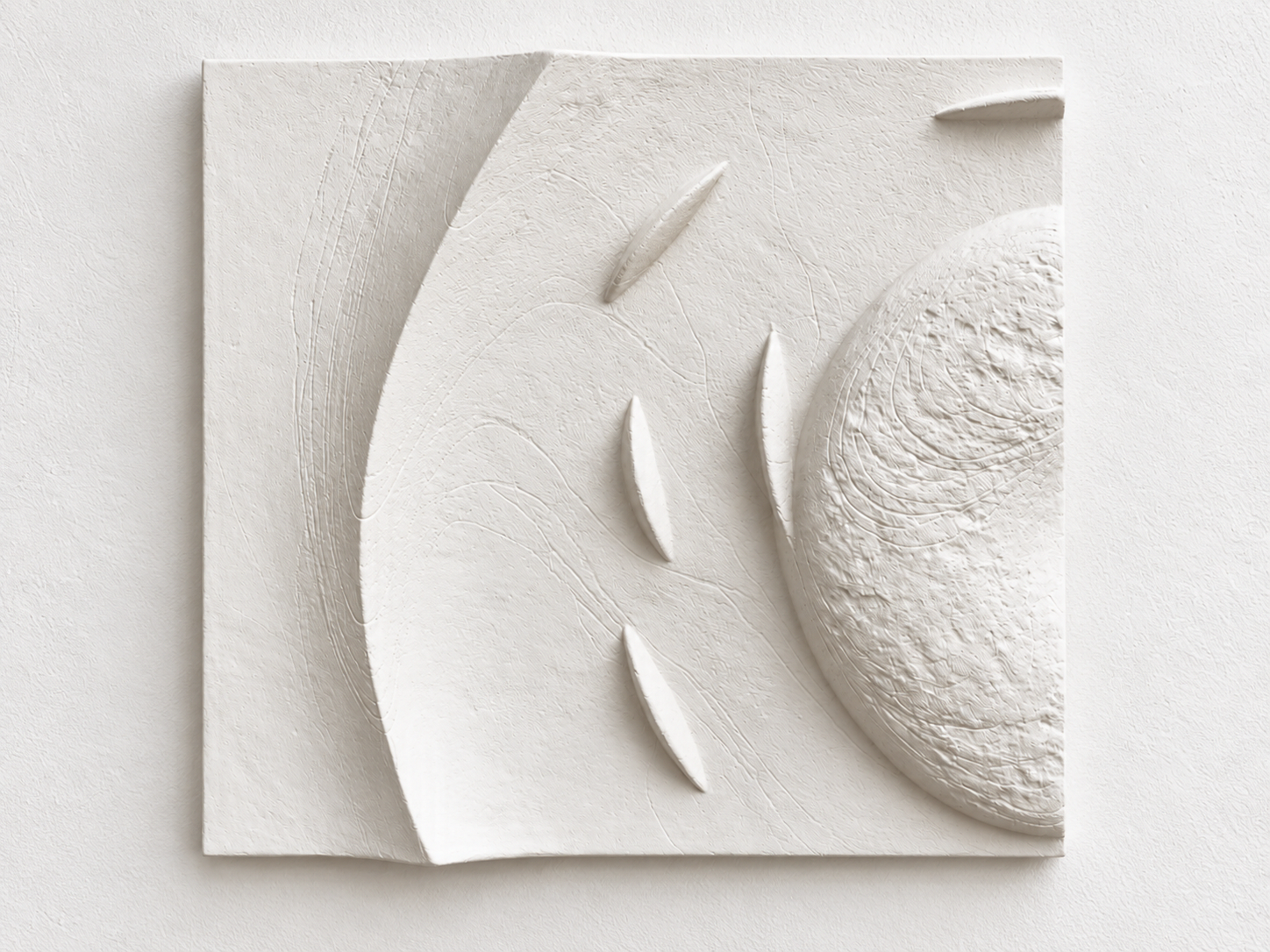 White Spiralfish Wave and Tide 1 relief with a broad curve, textured circle edge and fish-like forms.