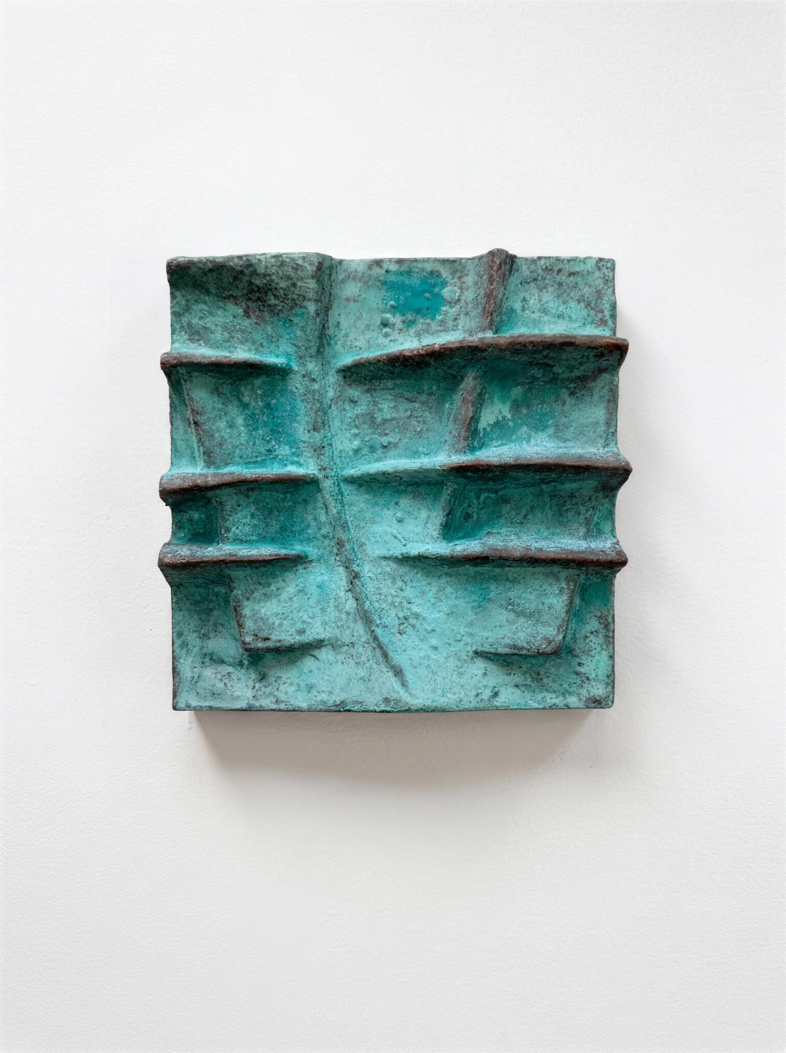Green verdigris Strata panel with horizontal raised ledges, mounted on a white wall.