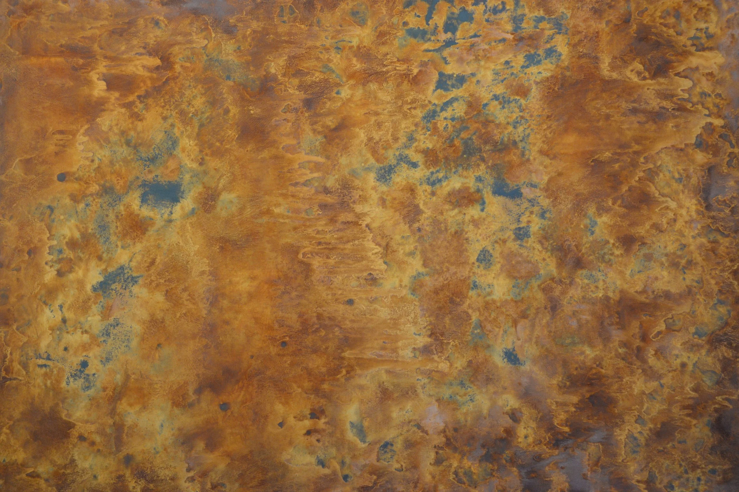 Close-up of the mottled rust, ochre and blue surface on the wide textured panel.