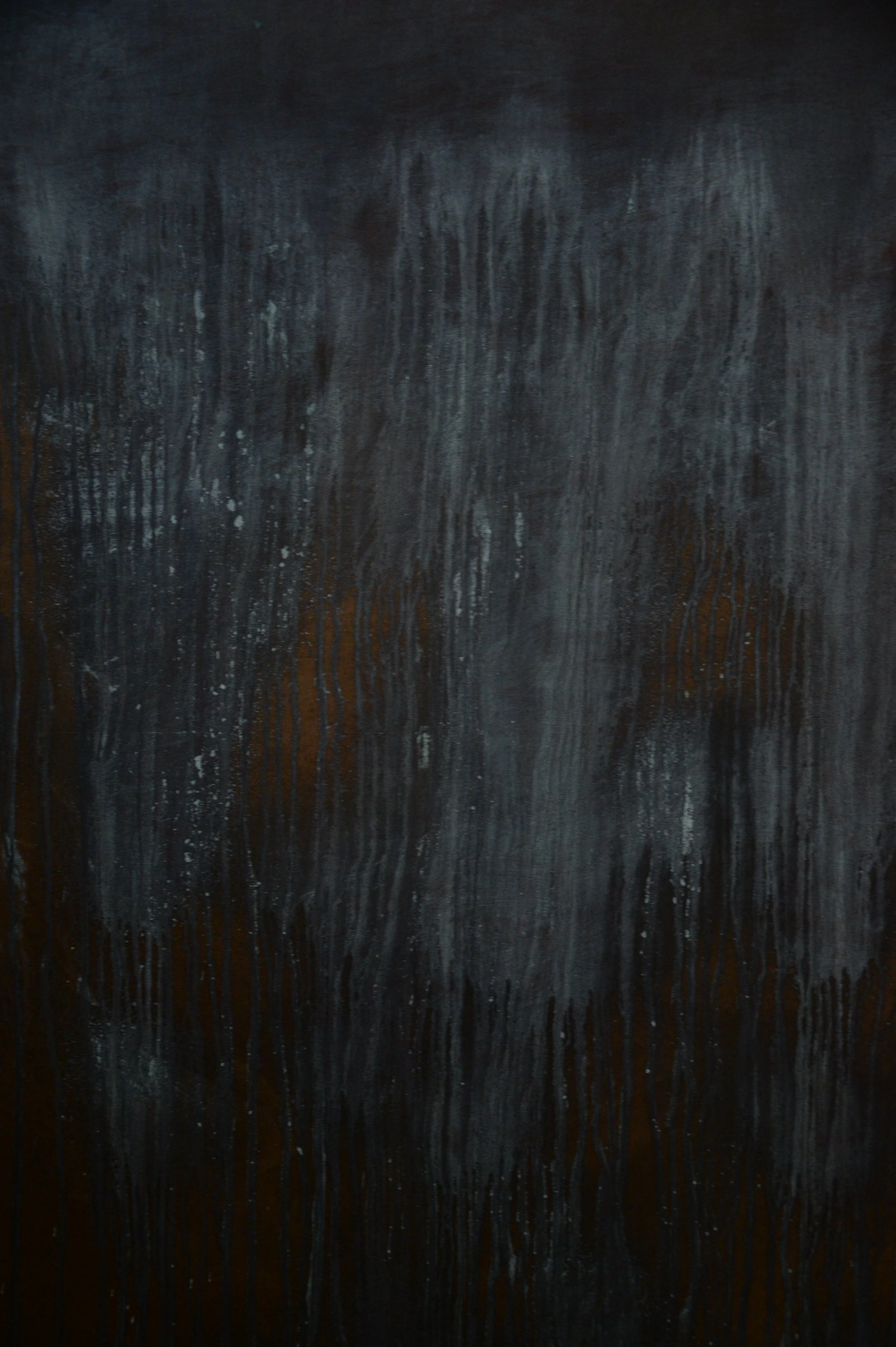 Vertical view of the dark textured panel showing blue patina and rusty streaks.