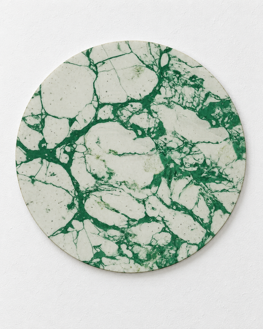 Green and white marbled circular wall panel against a white background.