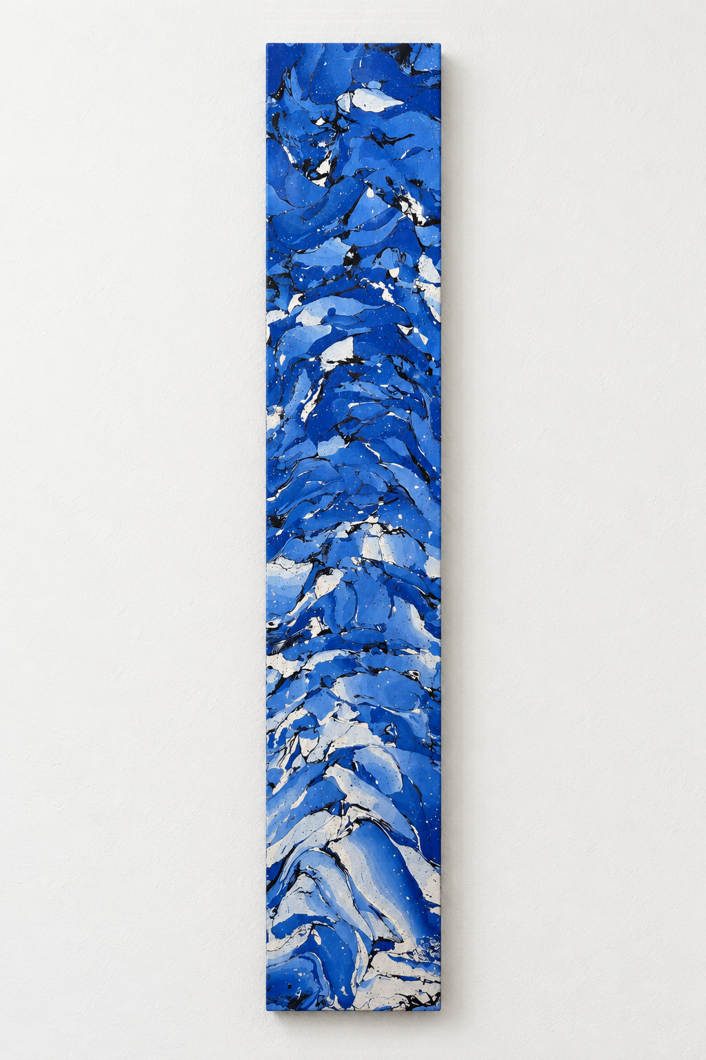 Azure blue and white marbled panel mounted vertically on a pale wall.