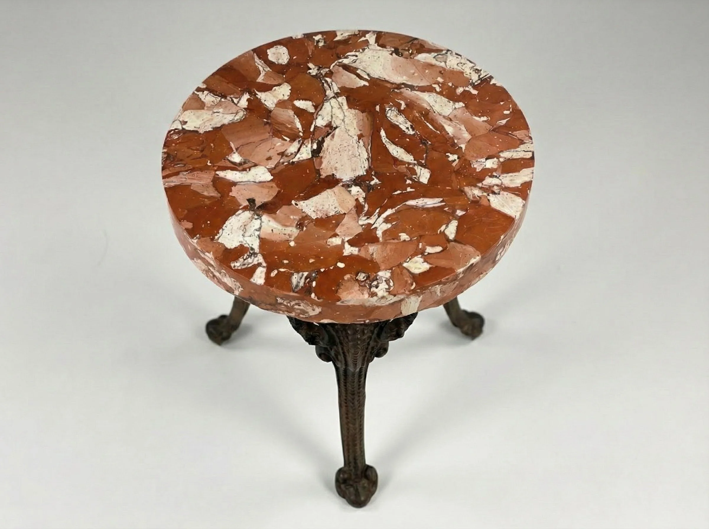 Terracotta Top Accent Table seen from the side, its marbled round top on slender cast metal legs
