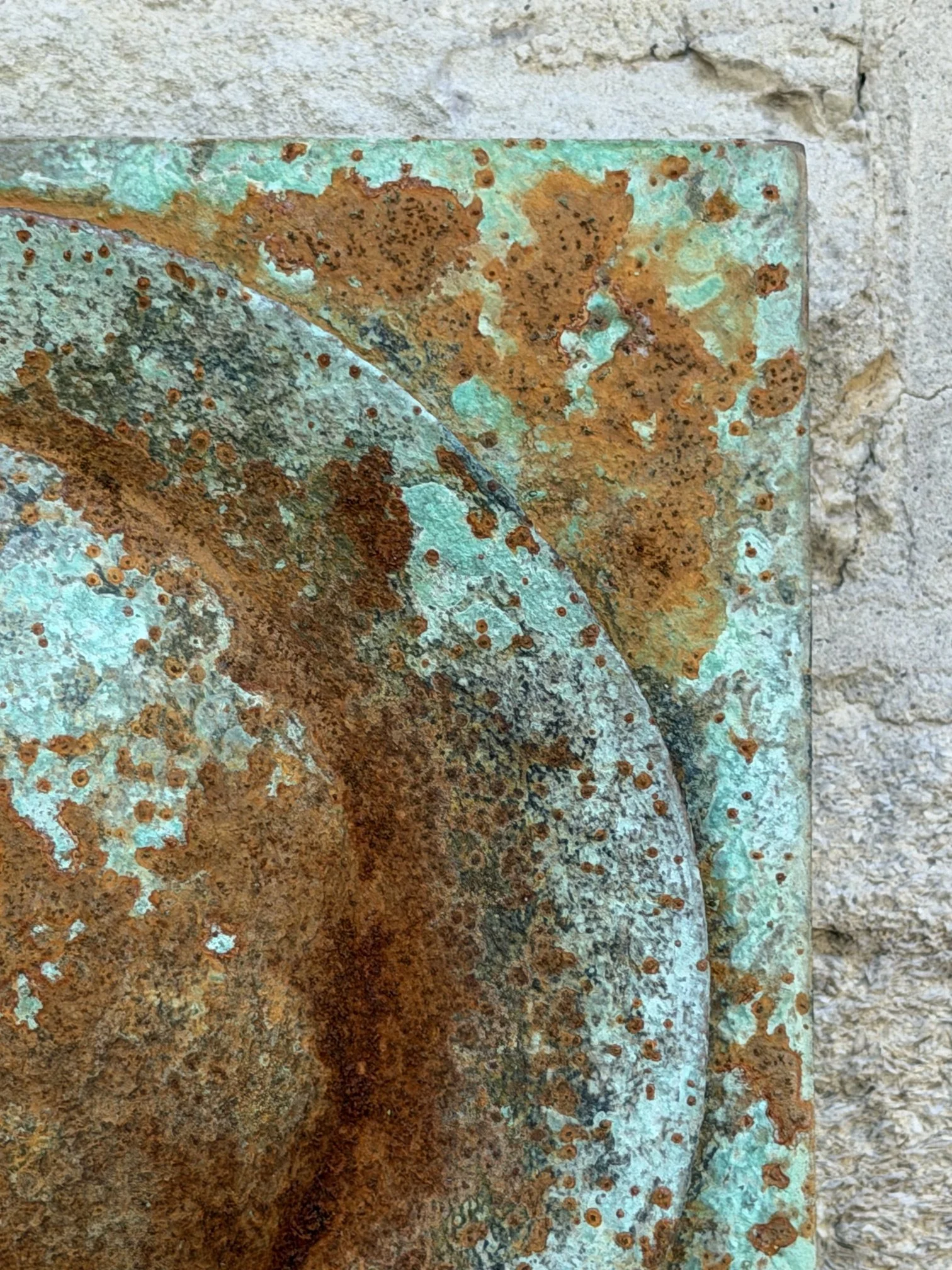 Close detail of the Moon Crater Verdigris Rust Wall Sculpture showing rust eating into the verdigris rim