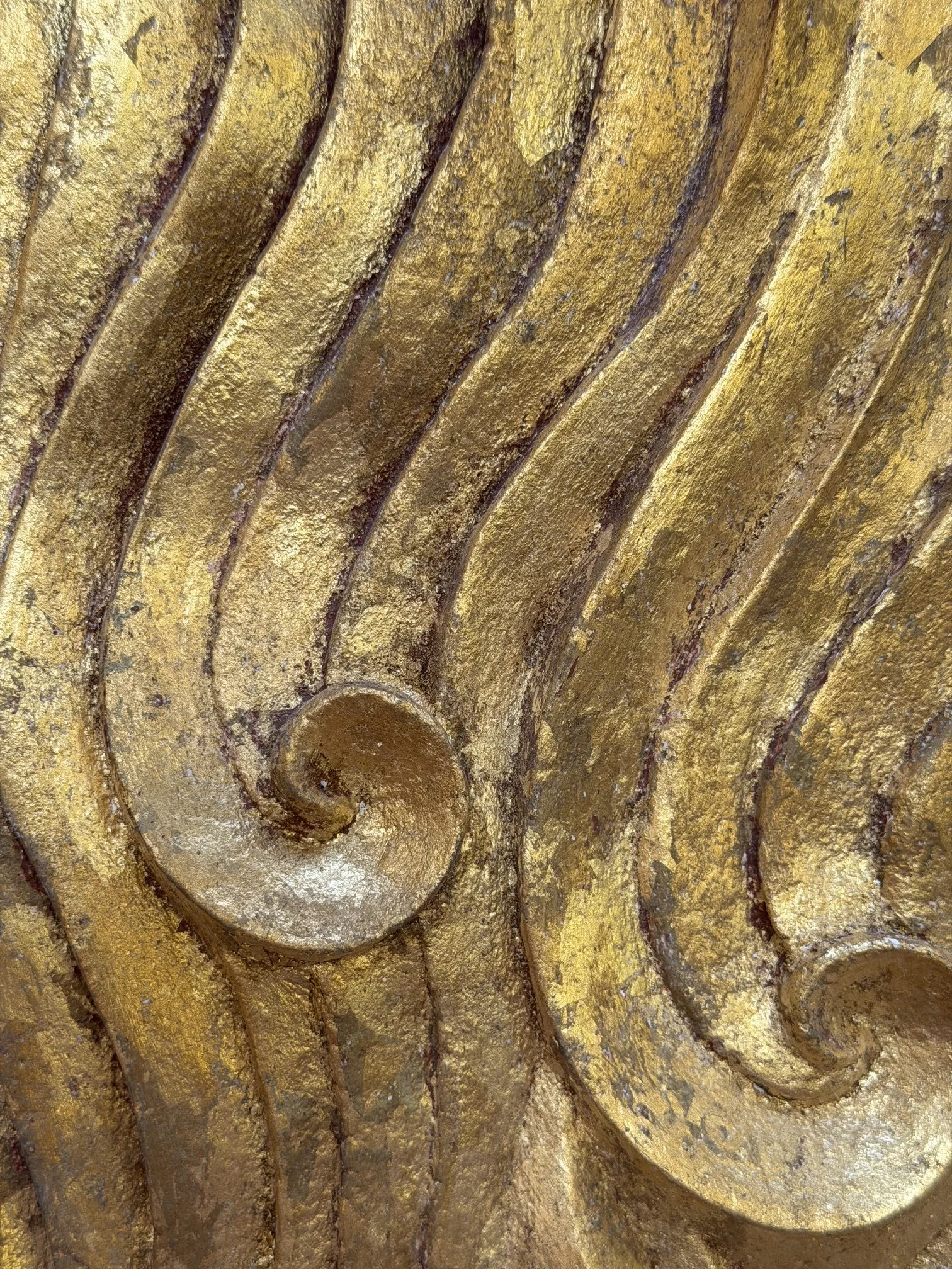 Close detail of the Gold-Leaf Wave Relief Sculpture showing gold leaf broken over the carved waves