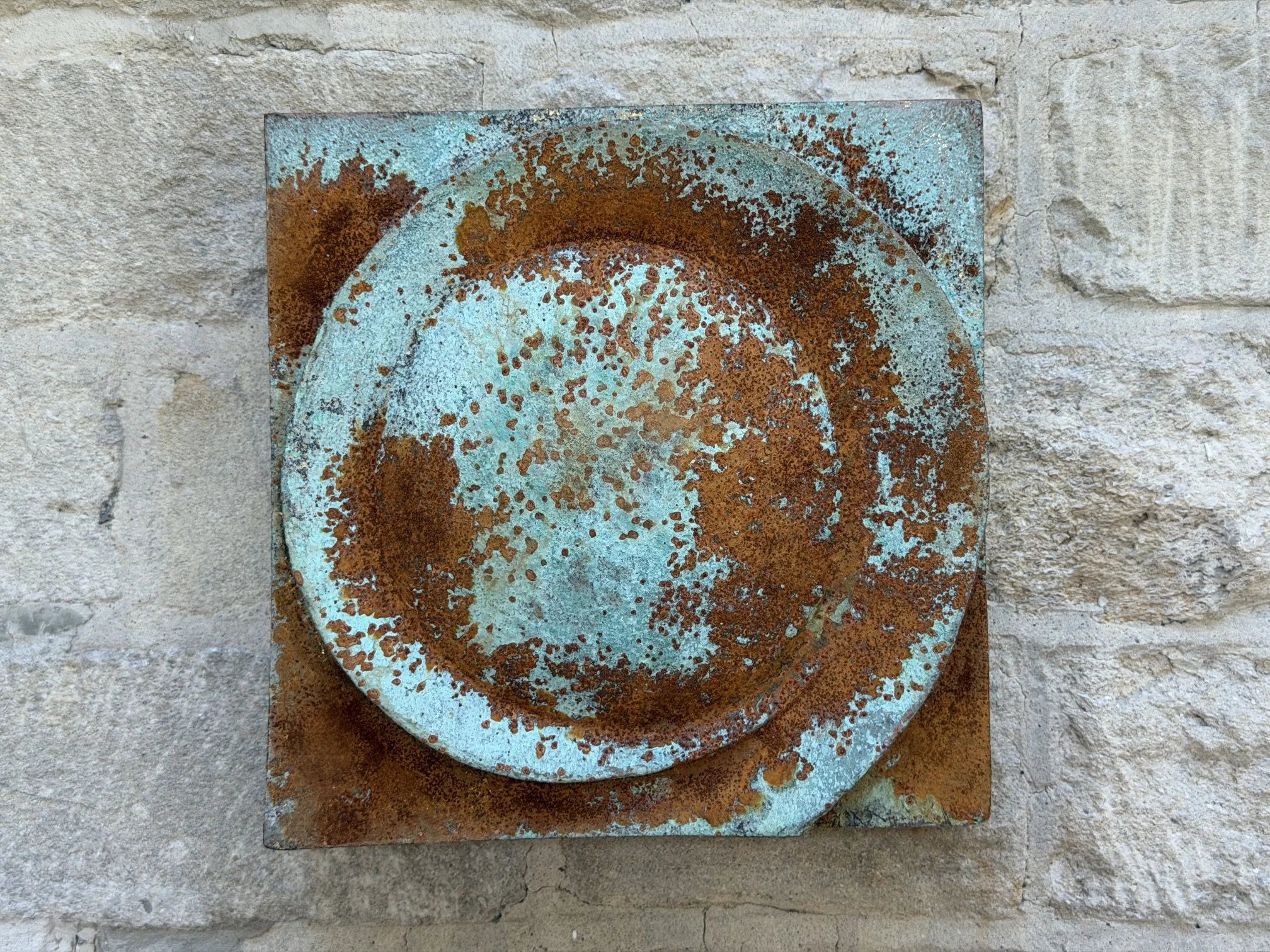 Close view of the Moon Crater Phase Blue Wall Sculpture showing the rust and turquoise patina of the crater disc
