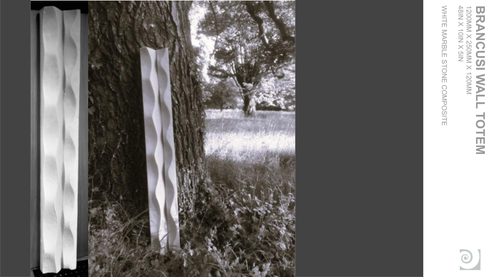 A white, wall-mounted, wave-shaped ceramic or stone decor element on a tree trunk in a park or natural setting.
