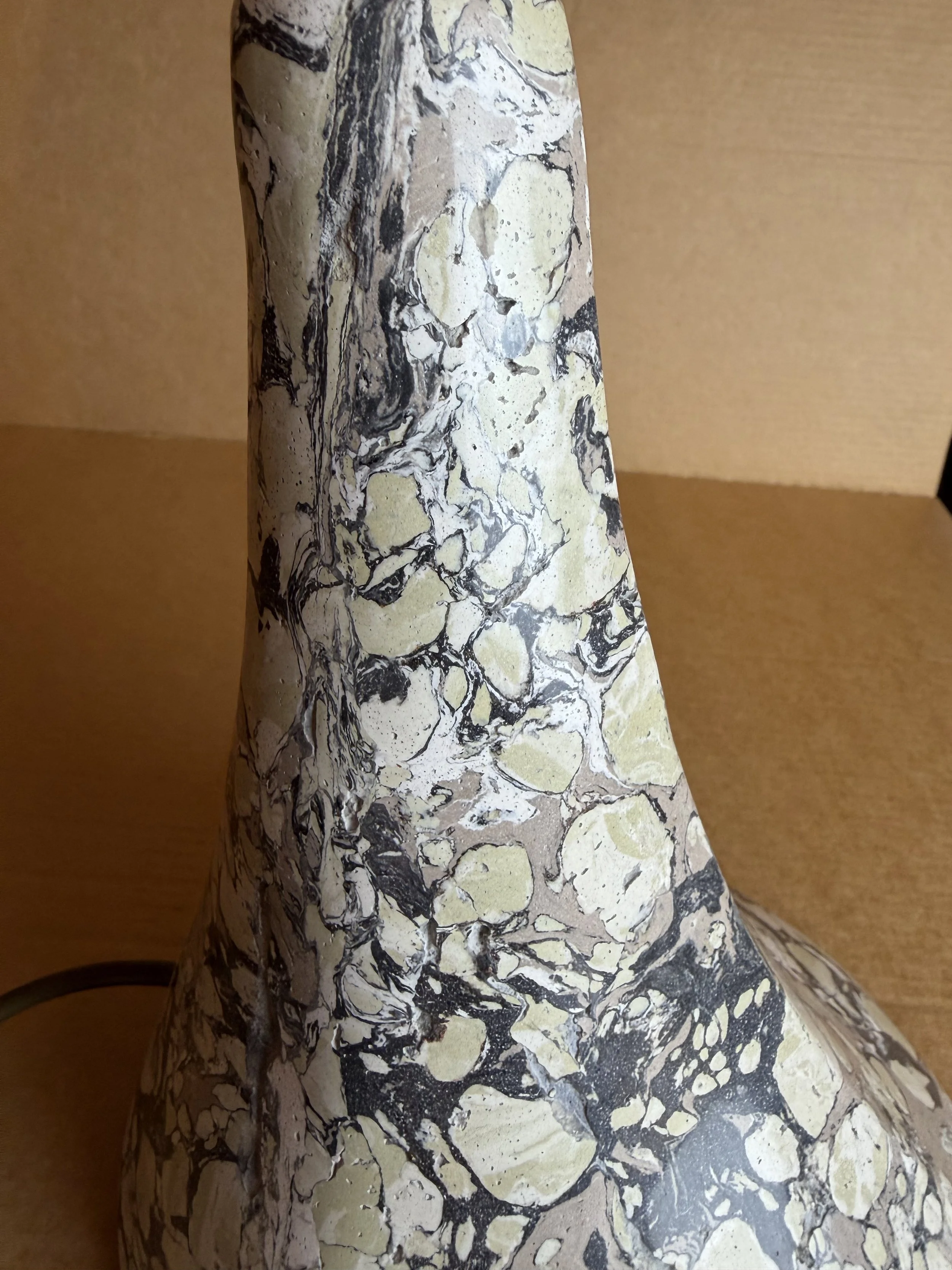 Green and Cream Lamp base photographed close in, the marbling running up the curve of the cone