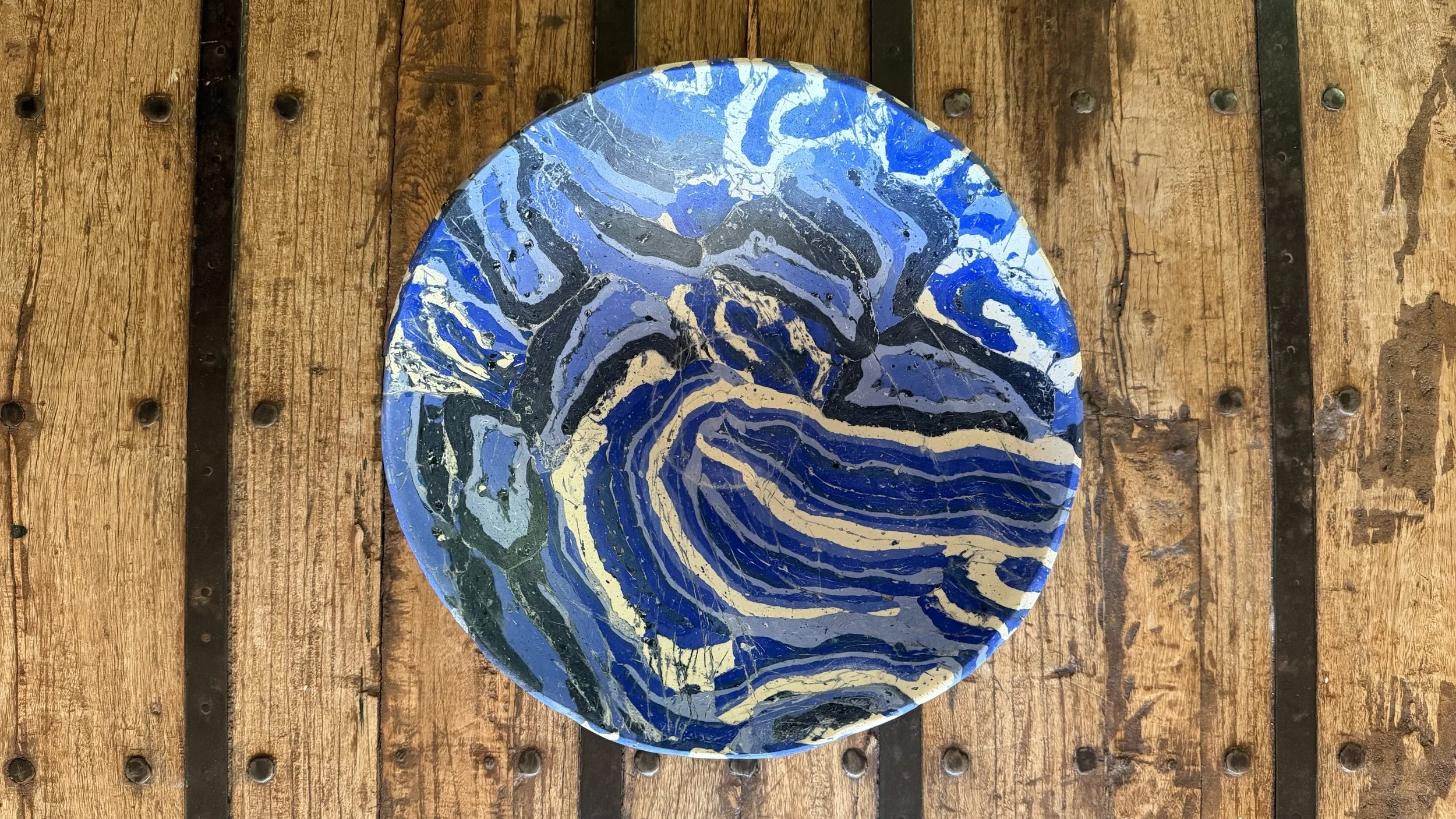 Blue Rustic Gypsum Bowl seen from above, its interior swirled with blue, gold and white