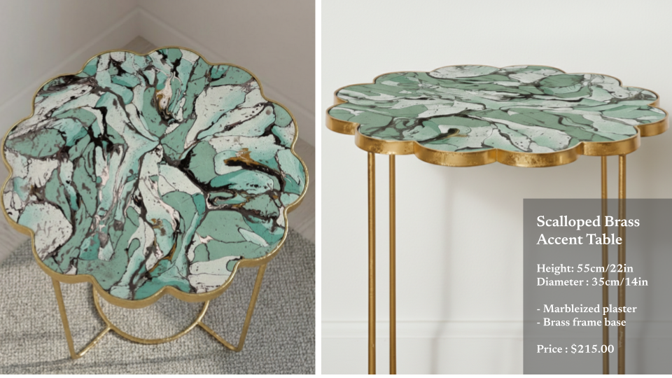 A marbleized plaster accent table with a scalloped brass frame, showing a green, white, and black marble pattern, tall and round with gold-colored metal legs.