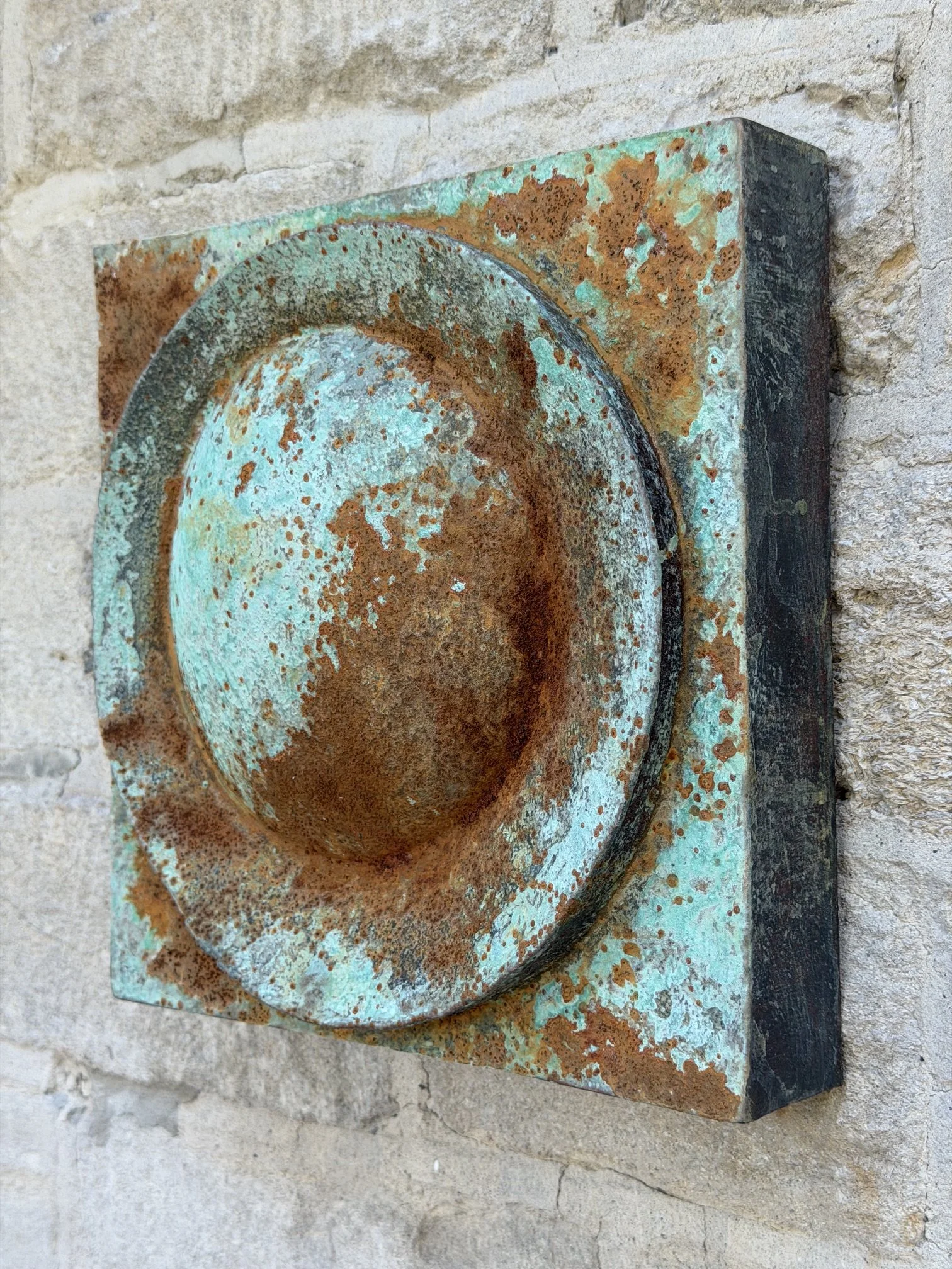 Moon Crater Verdigris Rust Wall Sculpture in profile, showing how far the panel stands off the wall