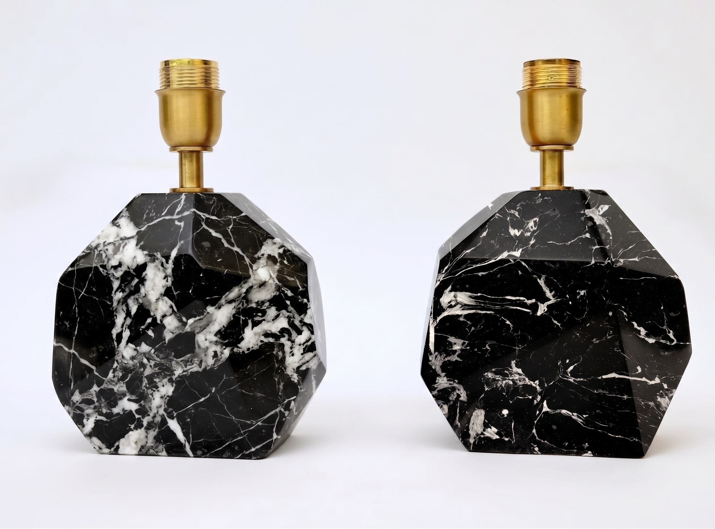 A pair of Faceted Black Marbelised Lamp Bases shown side by side with brass fittings