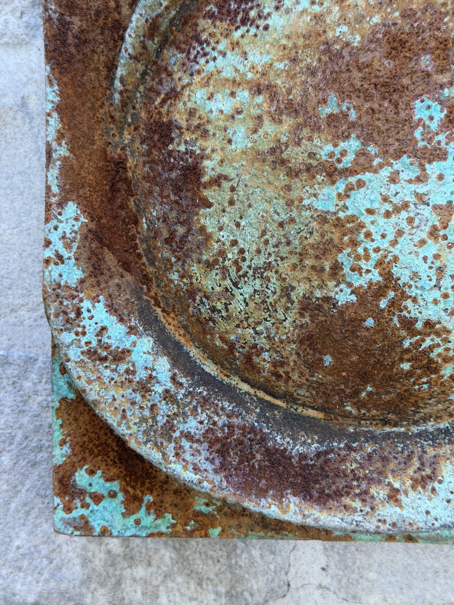Detail of the Moon Crater Phase Verdigris Spherical Wall Sculpture showing the crater rim and rusted centre