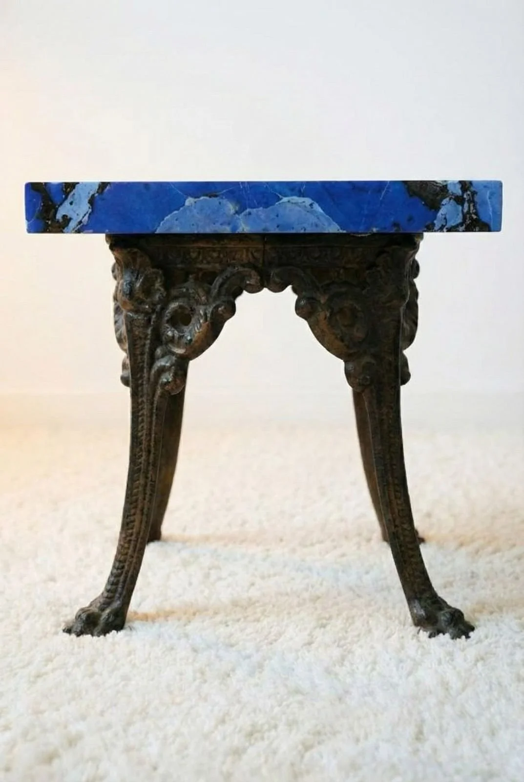Azure Elegance Art Table seen from below, showing the decorative cast metal legs and claw feet