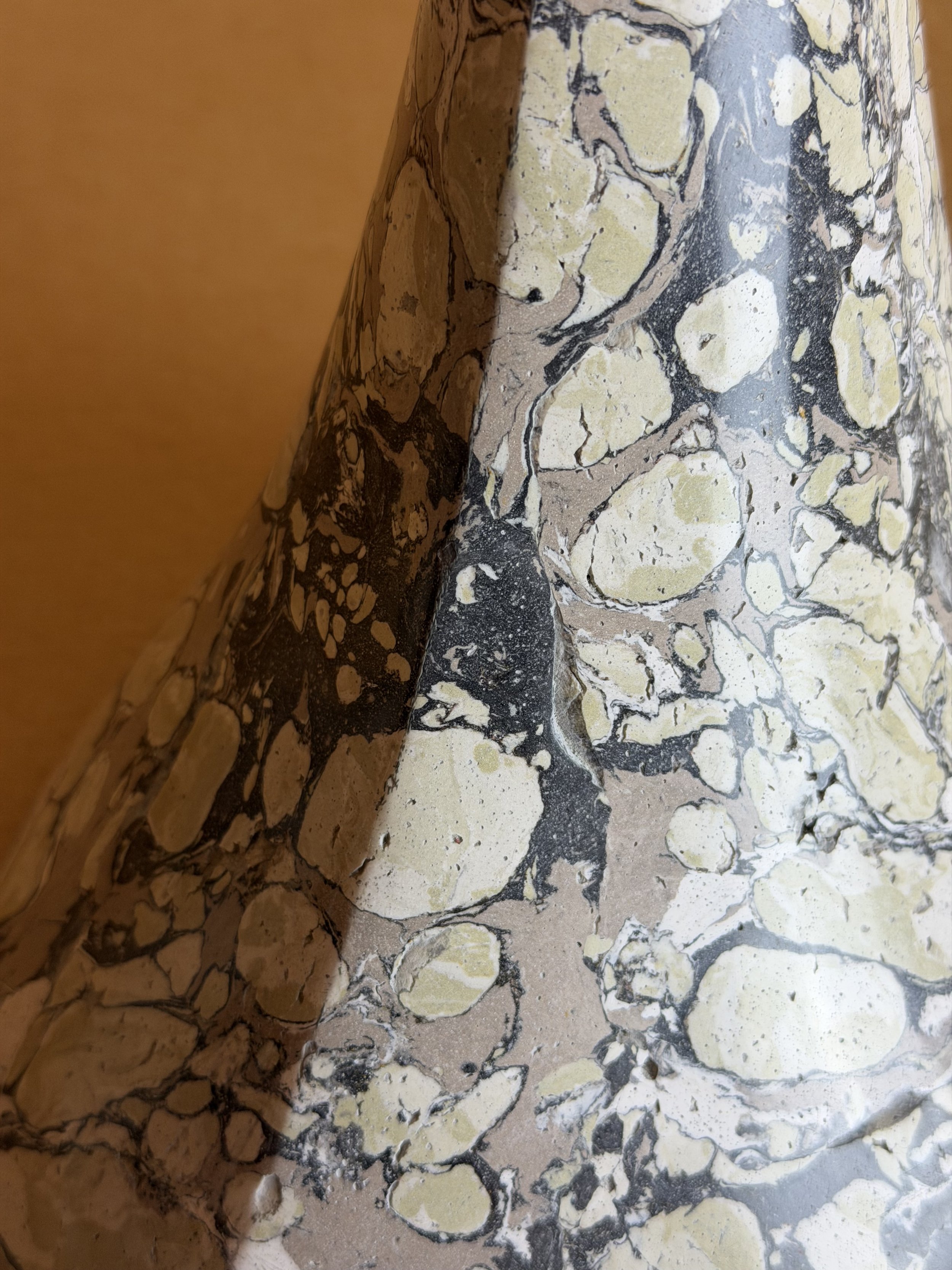 Close detail of the Green and Cream Lamp base marbling, cream pebbles over charcoal veining