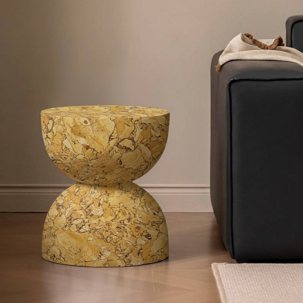 Cracked Caramel Marble Side Table beside a dark leather sofa in a pale interior