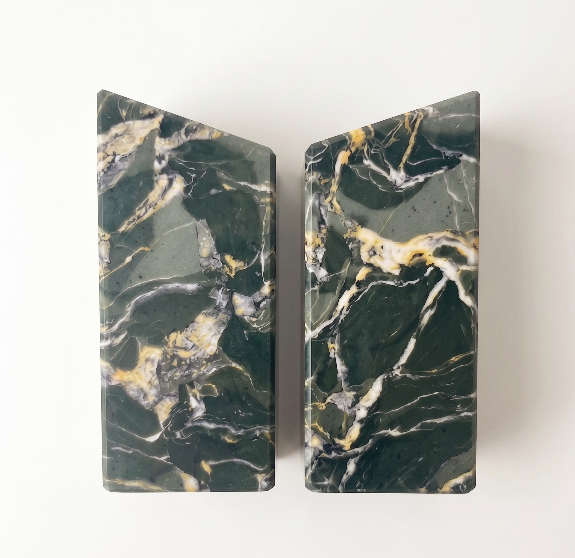 A pair of High Green Marbleized Bookends standing back to back on a pale surface