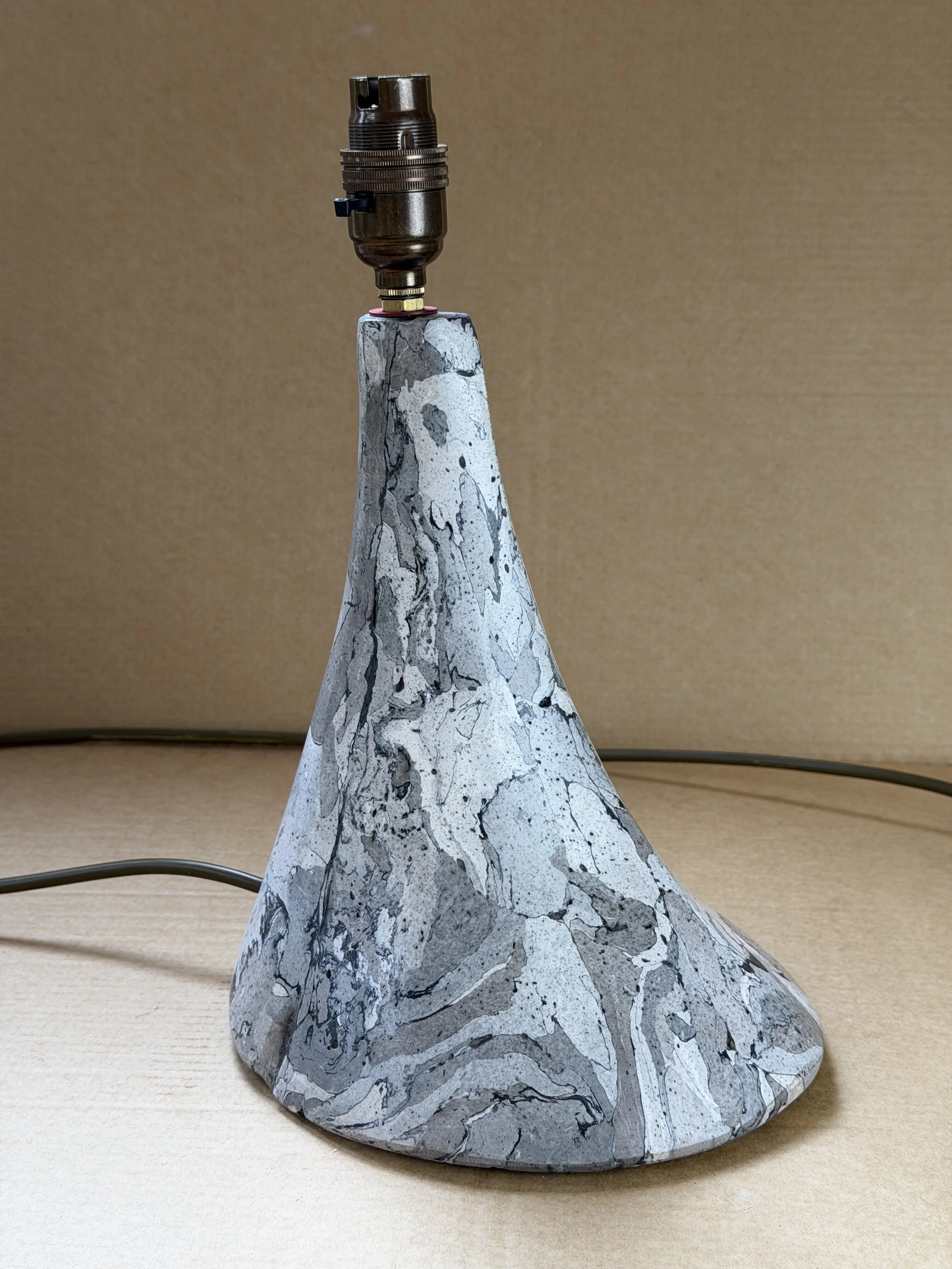 Gray Marble Table Lamp base with a brass lamp holder, its grey and white marbling sweeping up the cone