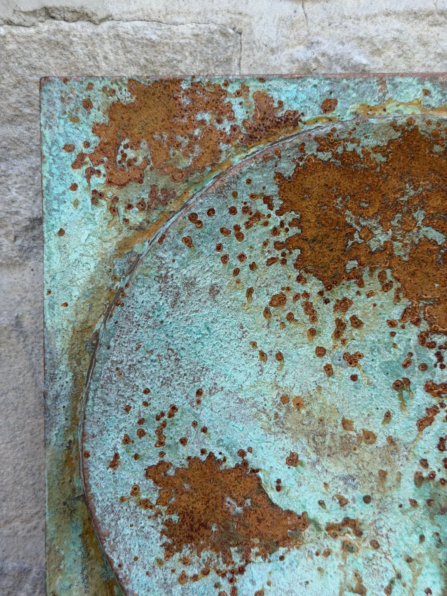Close detail of the Moon Crater Phase Copper Verdigris surface, rust flecks over turquoise patina