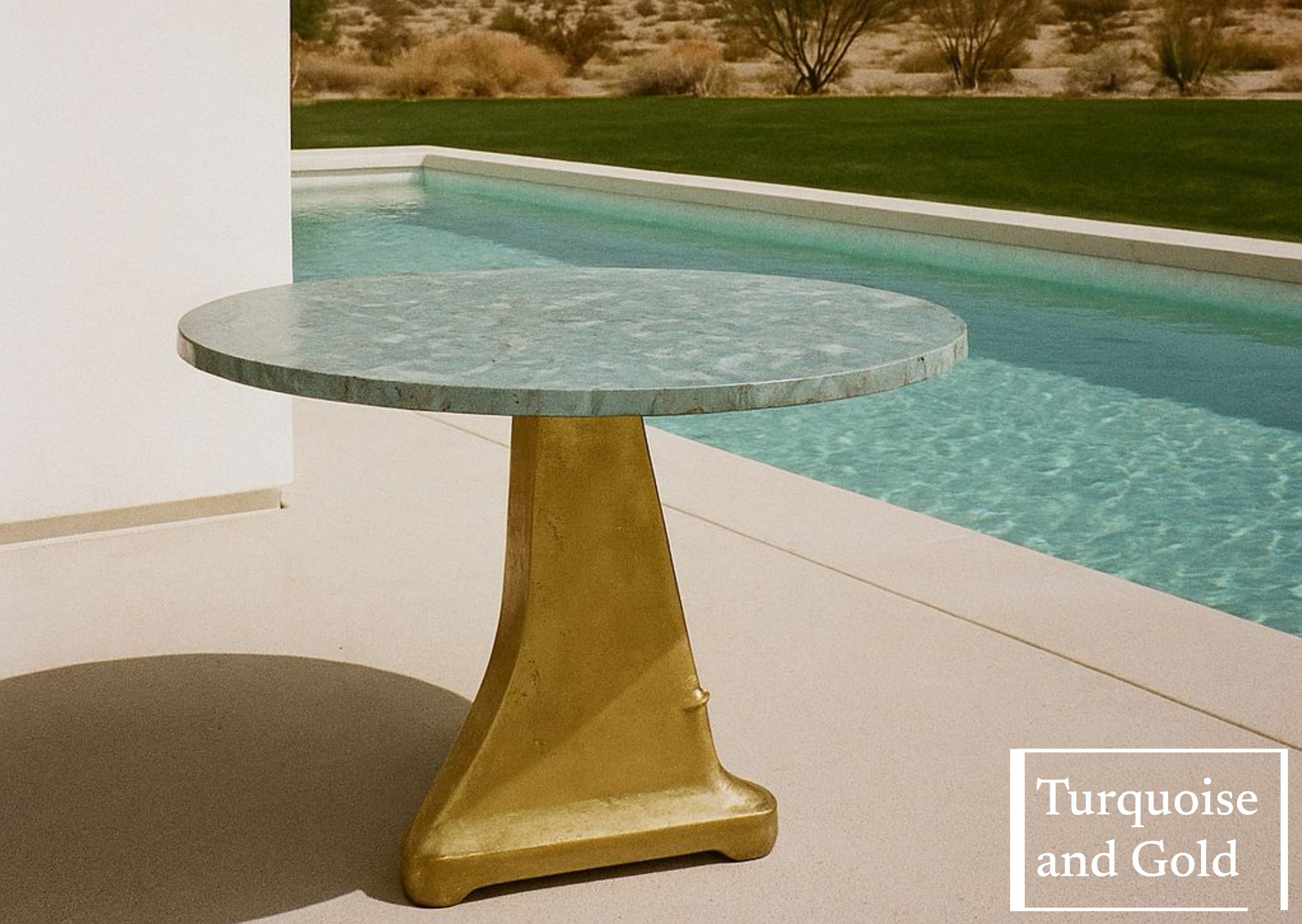 A round turquoise marble table with a gold pedestal base situated on a poolside patio, overlooking a swimming pool with desert landscape in the background.