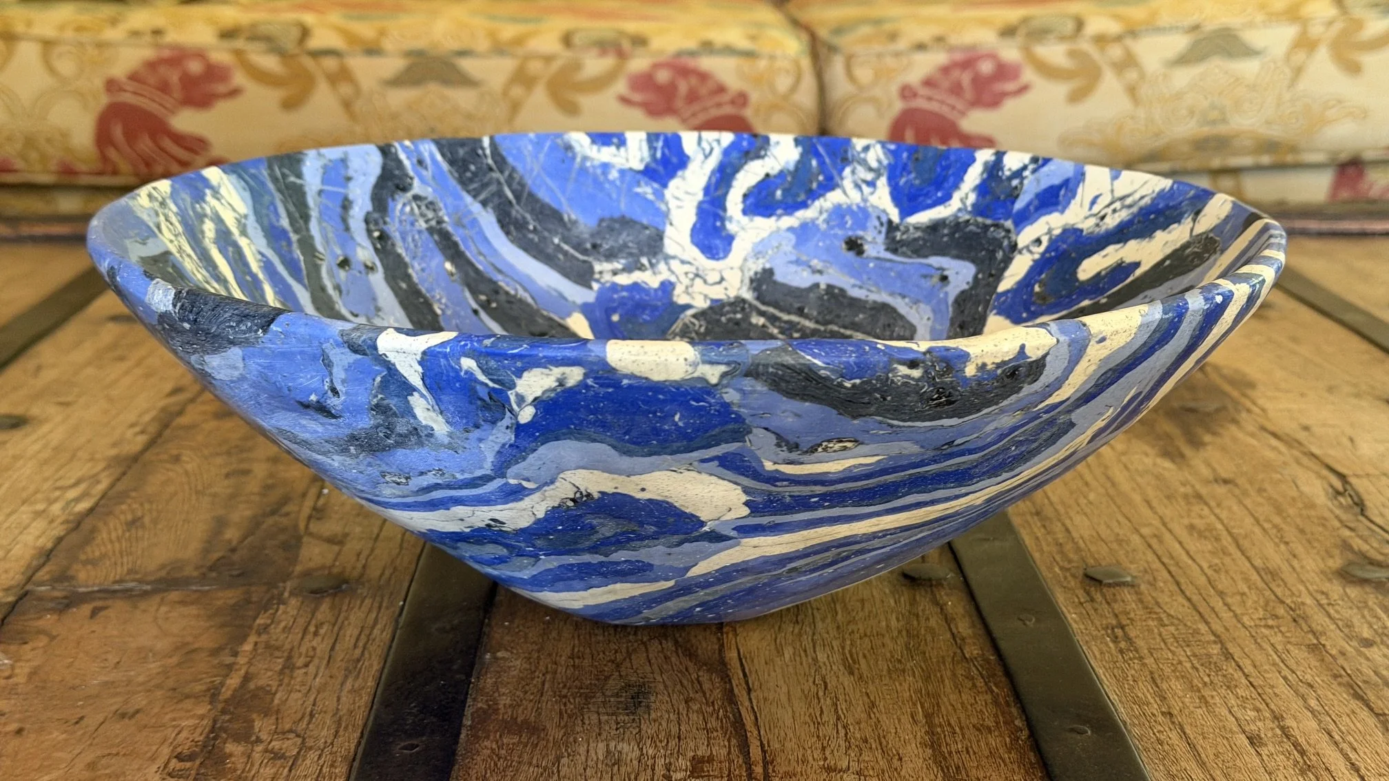 Blue Rustic Gypsum Bowl seen from the side on a rustic timber table