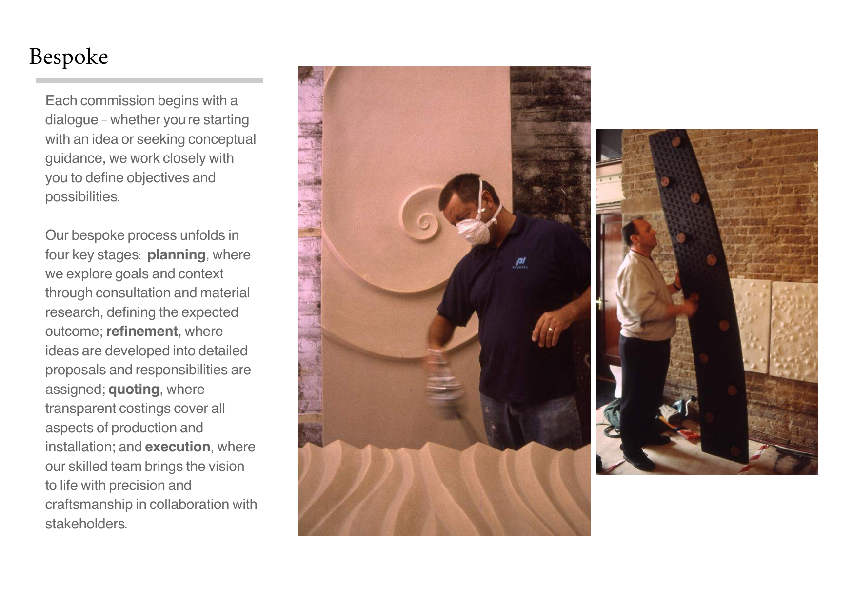 Two men working on interior design or installation, one wearing a mask and holding a tool, the other holding a large black textured panel with circular orange accents, against exposed brick and textured wall backgrounds.