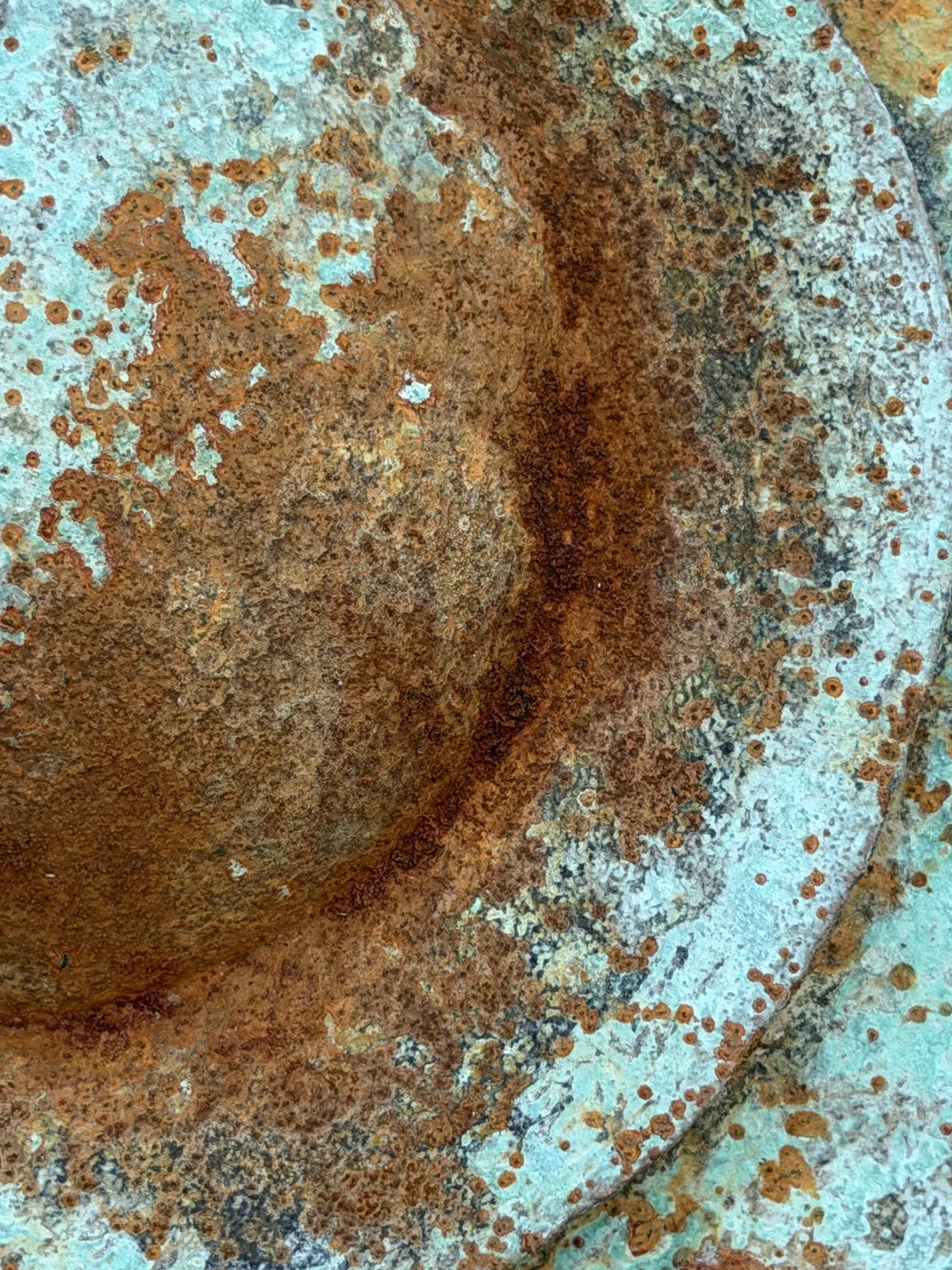 Close detail of the Moon Crater Verdigris Rust Wall Sculpture showing rust pooling in the crater