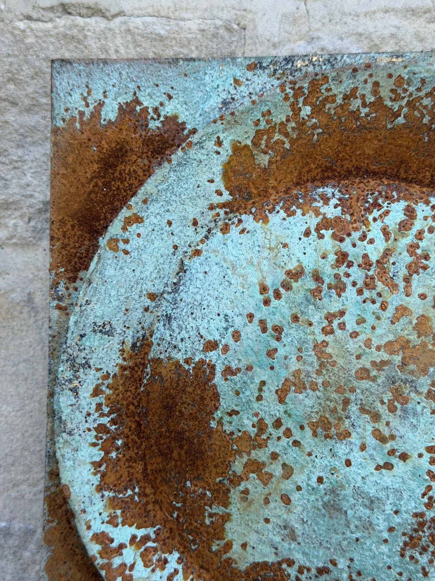 Close view of the Moon Crater Phase Blue Wall Sculpture showing the rusted rim around the pale blue crater