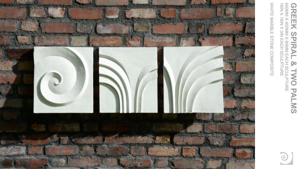 Three white marble square sculptures with spiral and curved line patterns mounted on a red brick wall.