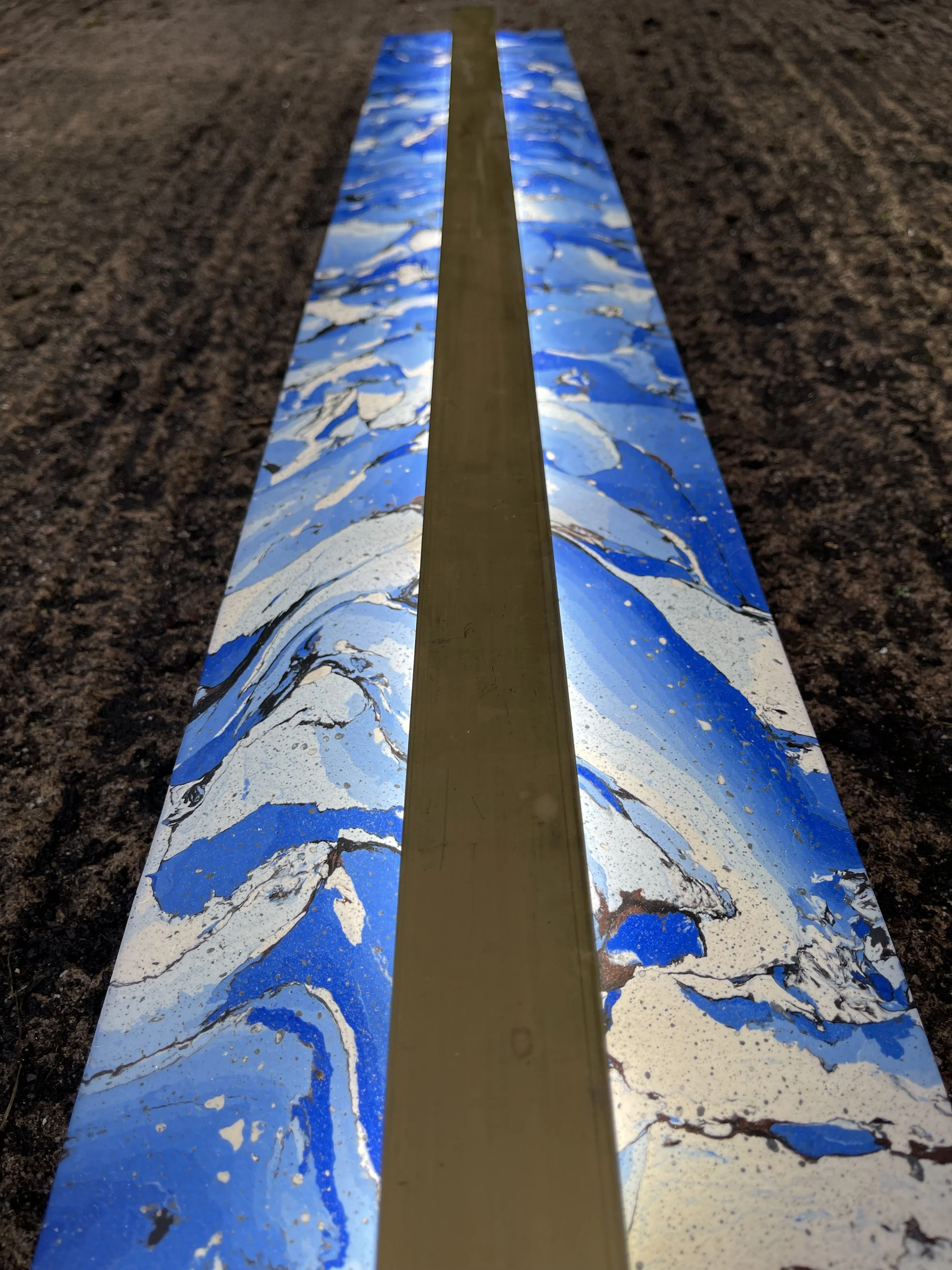Close view of the Shattered Blue Sconce showing the brass strip inlaid into the blue marbled panel