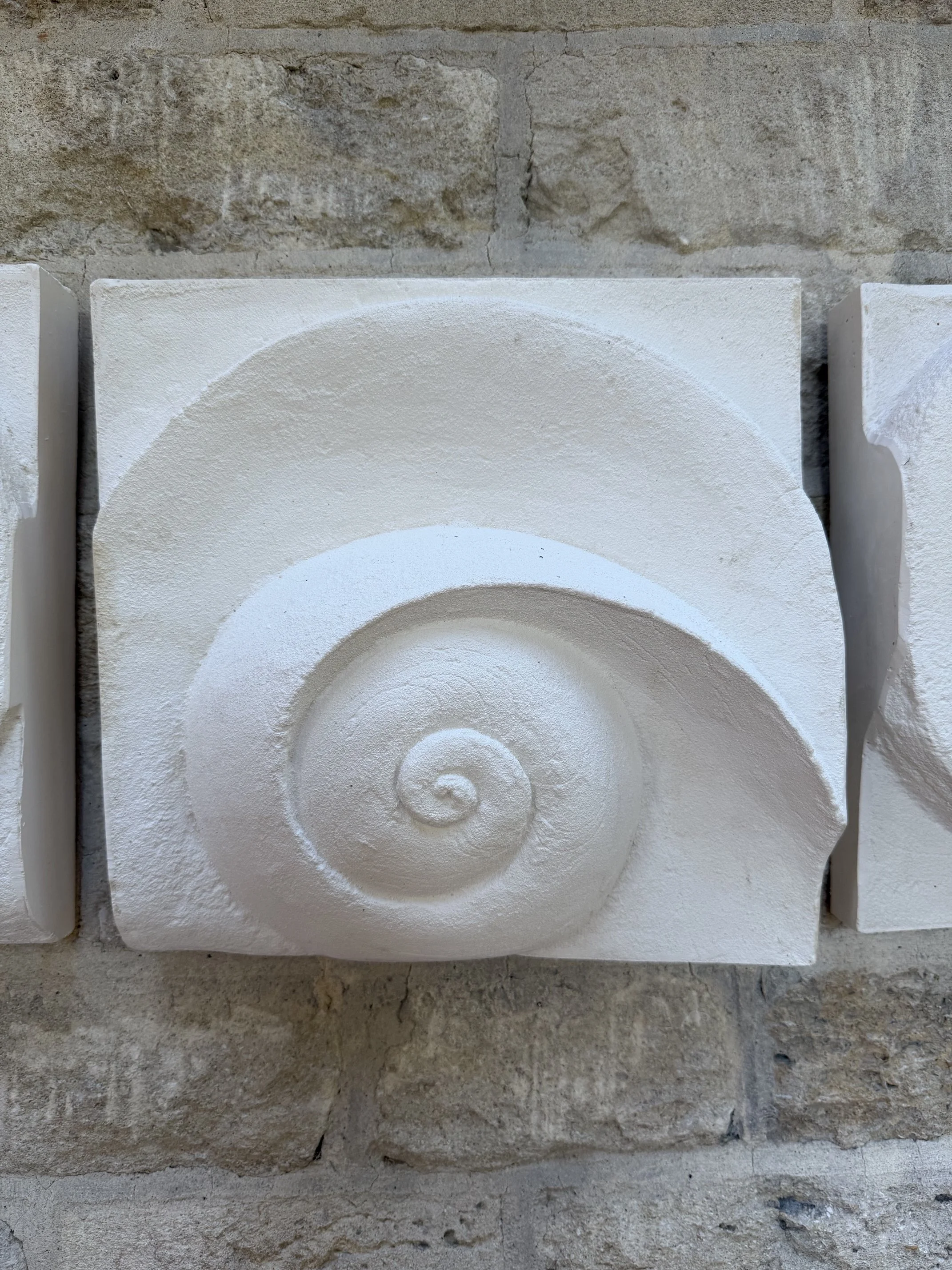 Close view of the Wave Phase White Wall Sculpture showing the coiled centre of the carved wave