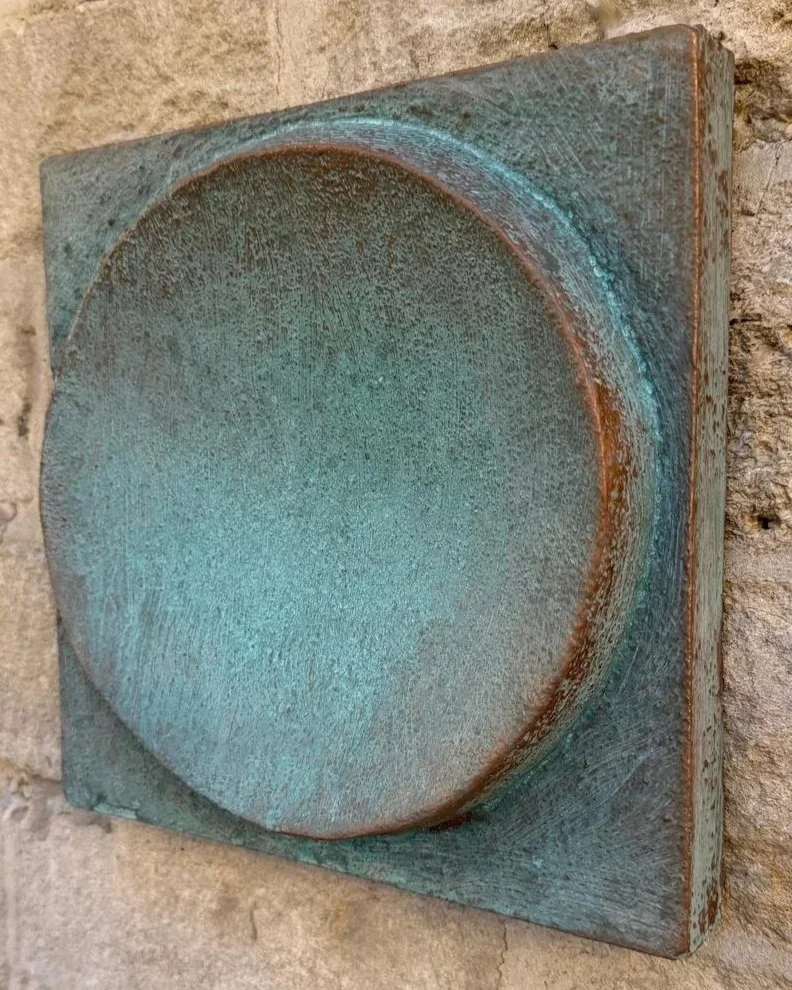 Spherical Verdigris wall sculpture seen at an angle, showing the depth of the verdigris dome