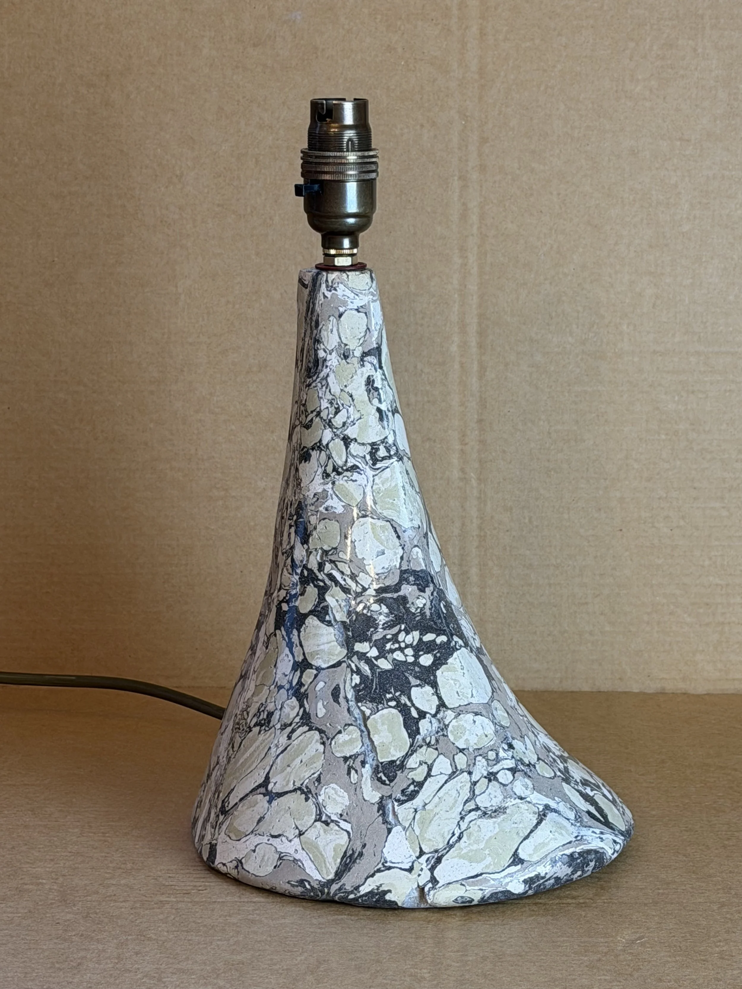 Green and Cream Lamp base seen from the front, its brass lamp holder above the marbled cone
