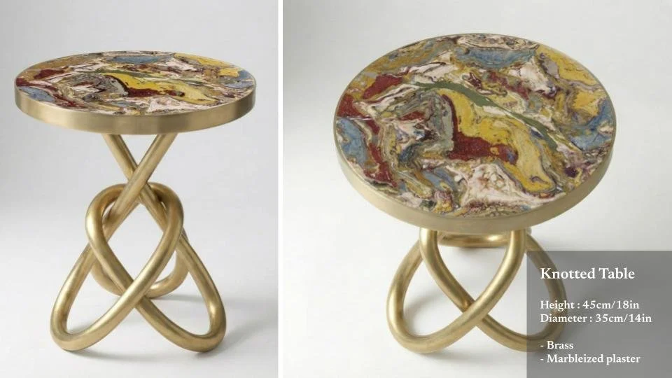 A knotted side table with a marbleized plaster top and a gold-colored brass twisted knotted base, shown from side and top angles, with details about its height, diameter, material, and finish.