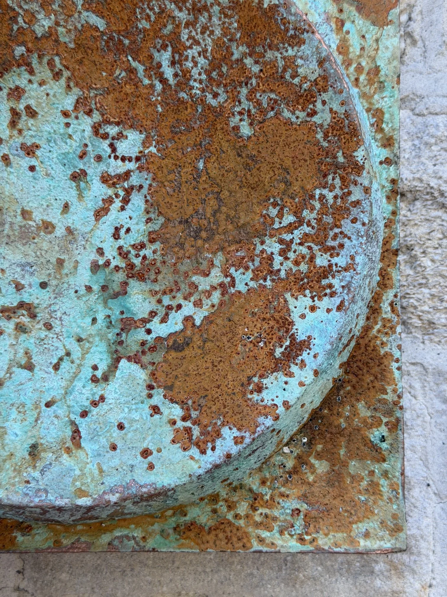 Detail of the Moon Crater Phase Copper Verdigris Wall Sculpture showing the speckled crater surface