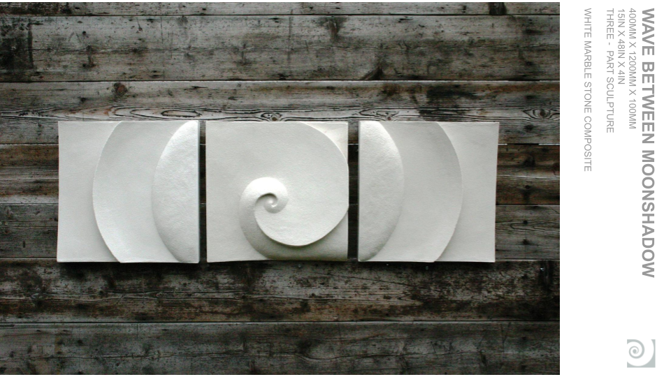 White marble sculpture composed of three square blocks with a spiral design in the center block, positioned on a weathered wooden surface.