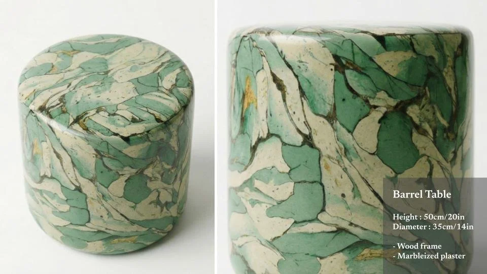 A marbleized green and beige barrel-shaped table with a wood frame, showing top and side views.
