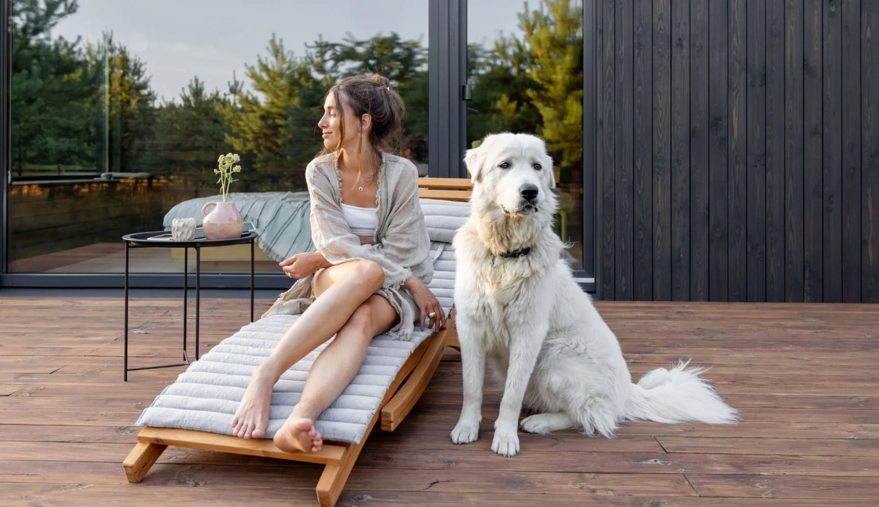 woman and dog in front of the house