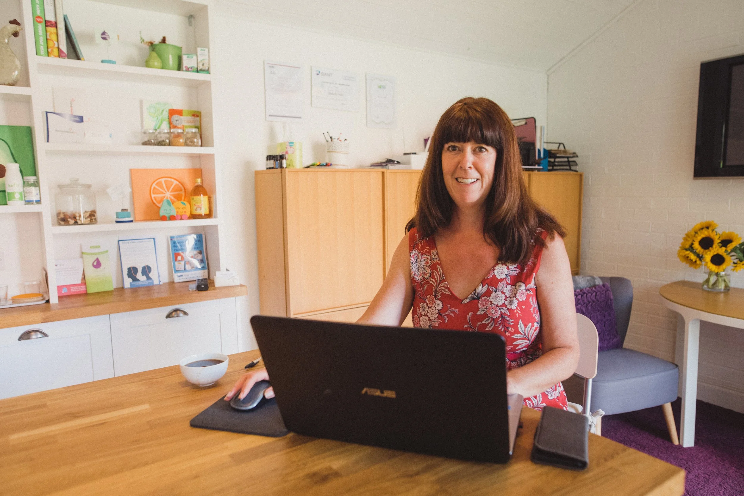 Wendy Hills Nutritional Therapist in kent, working laptop consultation