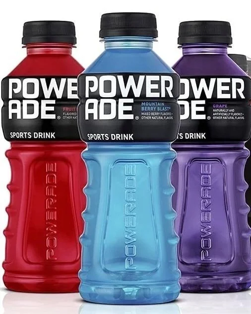 Three Powerade sports drinks displayed side by side in red, blue, and purple flavors.
