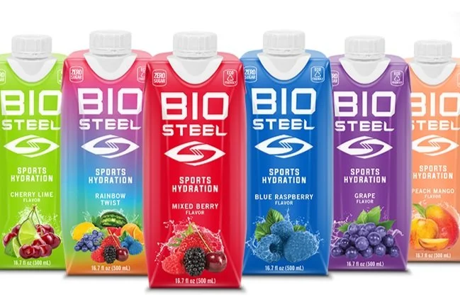 Six BioSteel sports drinks lined up in assorted colors representing different flavors.