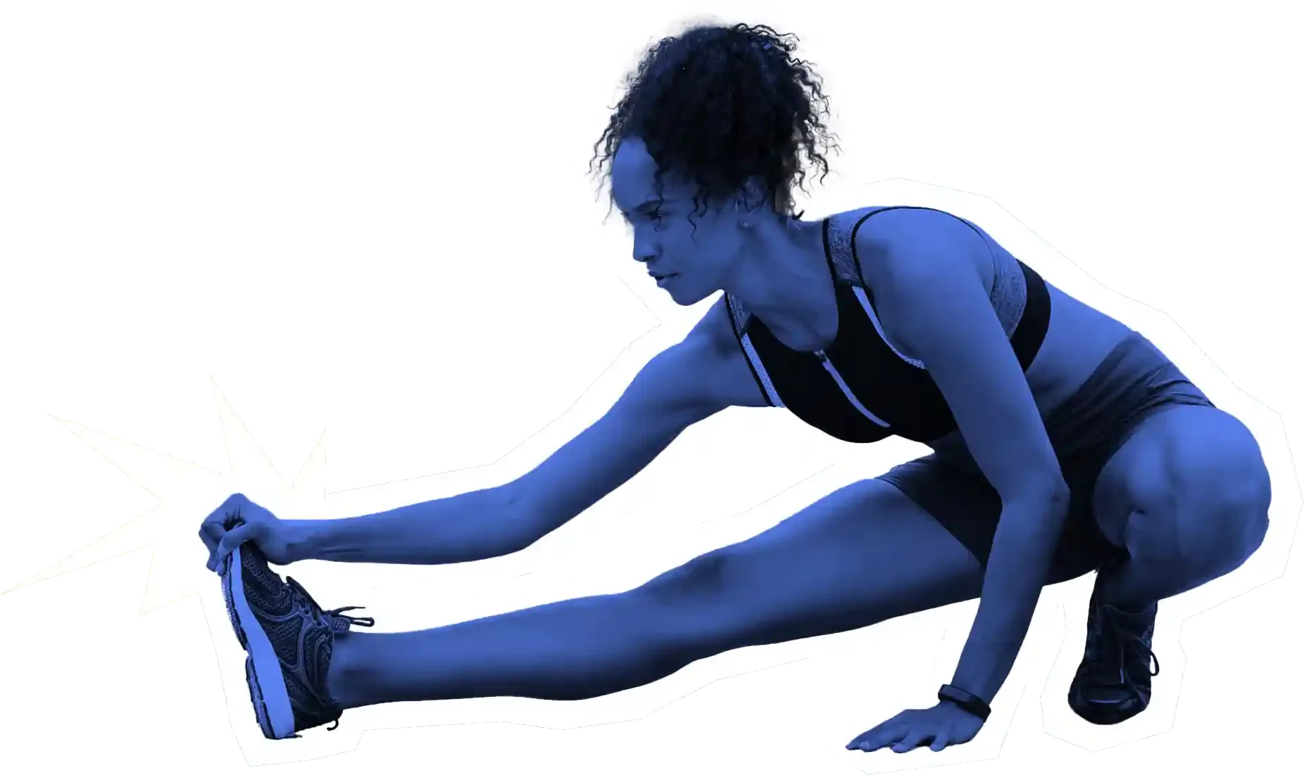 A woman in athletic clothing stretching on the floor, reaching for her foot with her hand