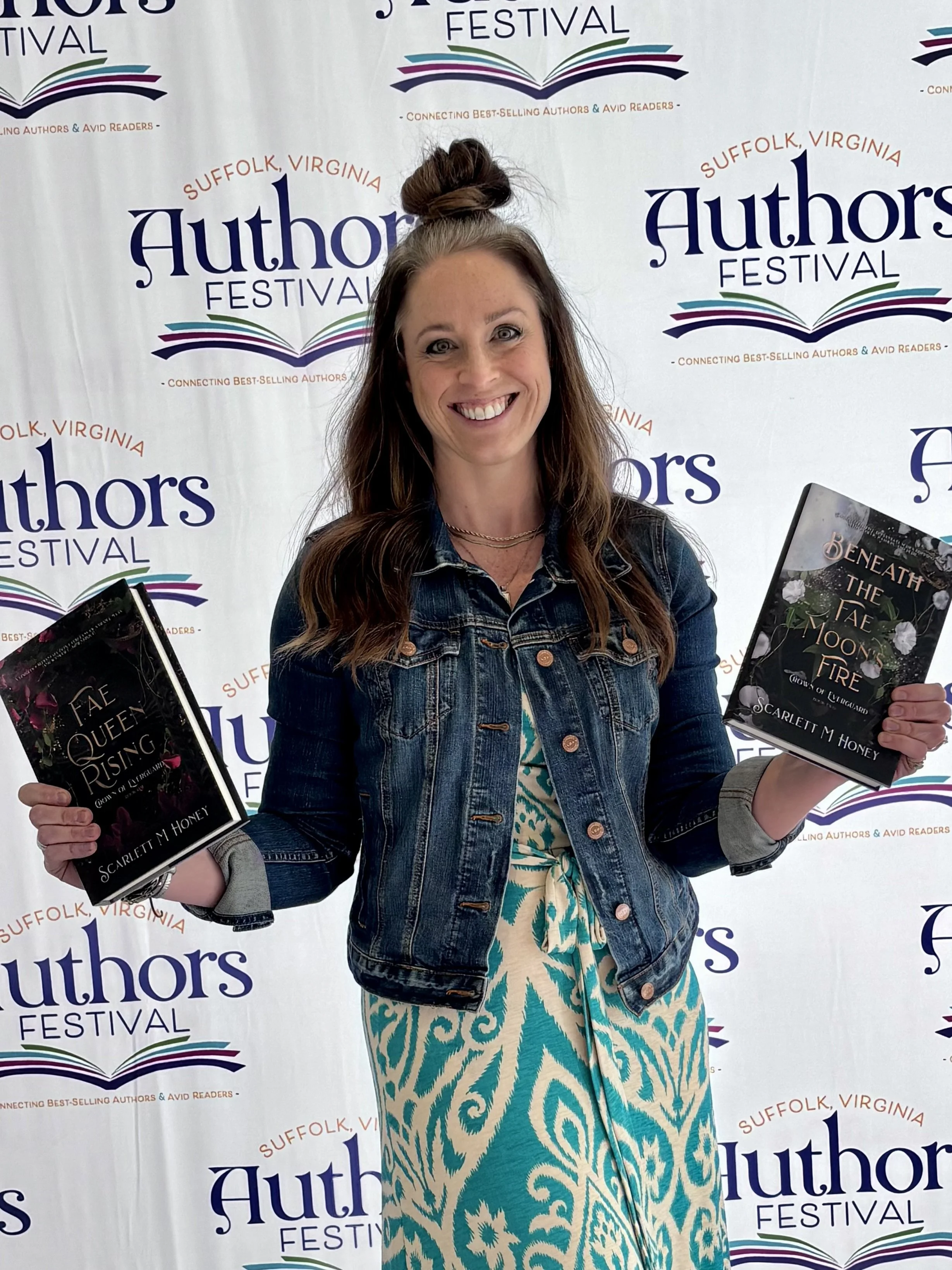 author SMH holding her two novels at Suffolk Author's Festival
